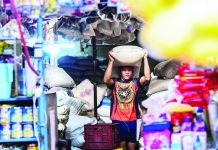 Sugar producers group backs revival of PhilSuCor Workers stack sacks of locally produced sugar at the Marikina Public Market in Marikina City on Tuesday, May 16. MARIA TAN/ABS-CBN NEWS PHOTO