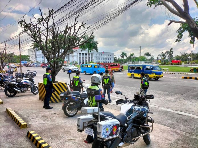 business_as_usual_ART_resized Personnel of the Bacolod City Police Office Traffic Enforcement Unit monitor the protest of some transport groups at the Government Center grounds on Monday, May 8. BCPO-TRAFFIC ENFORCEMENT UNIT