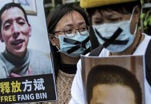 China frees jailed COVID whistleblower An activist holds a placard of missing citizen journalist Fang Bin, as she protests outside the Chinese liaison office in Hong Kong in 2020. AFP