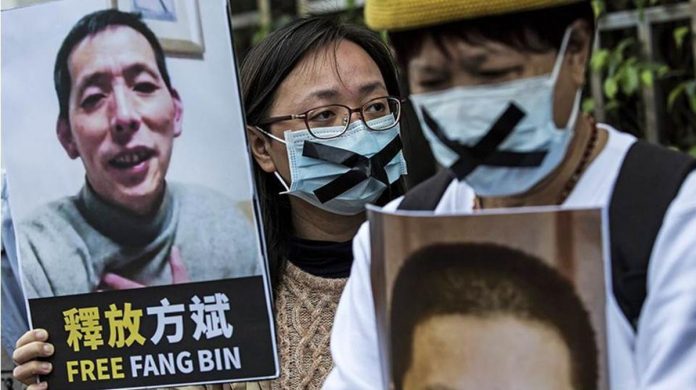 china_resized An activist holds a placard of missing citizen journalist Fang Bin, as she protests outside the Chinese liaison office in Hong Kong in 2020. AFP