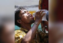 A man in Dhaka, Bangladesh drinks water amid a heatwave. GETTY IMAGES