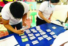 Assigned personnel distribute Bacolod City Comprehensive Health Program (BacCHP) family health membership cards to qualified beneficiaries. BacCHP aims to make access to medical services easier for indigent families. BACOLOD CITY PIO PHOTO