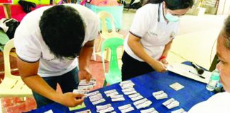Assigned personnel distribute Bacolod City Comprehensive Health Program (BacCHP) family health membership cards to qualified beneficiaries. BacCHP aims to make access to medical services easier for indigent families. BACOLOD CITY PIO PHOTO