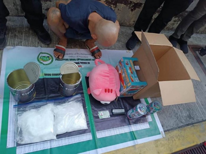 nation_shabu_resized This photo from the Philippine Drug Enforcement Agency shows a consignee-suspect and the confiscated crystal meth (locally known as “shabu”) worth P12,240,000 that was imported from San Jose City in California, United States. Authorities intercepted the illegal drug at the Port of Clark on May 9, 2023 then, in a controlled delivery operation, recovered the contraband from the suspect in Barangay Highway Hills, Mandaluyong City on May 11.