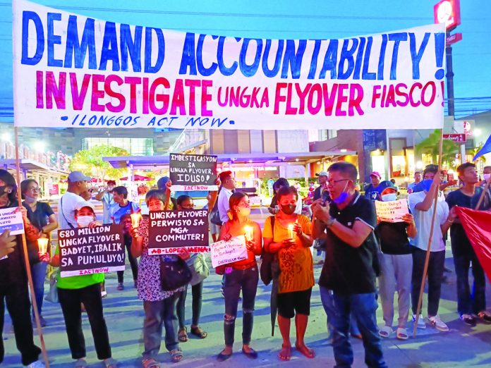 protest_1_resized Protesters light candles at the defective flyover in Barangay Ungka II, Pavia, Iloilo. They demand for an investigation. AJ PALCULLO/PN