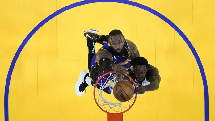 LeBron James of the LA Lakers and Jamychal Green of the Golden State Warriors fight for the ball. AP