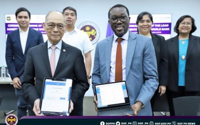 PH_loans_resized Finance Secretary Benjamin Diokno (left) and World Bank Country Director for the PH Ndiamé Diop sign four loan agreements on Monday, June 26. The agreements amounting to USD1.14 billion will support economic recovery, agriculture, education, and sustainability. DOF PHOTO