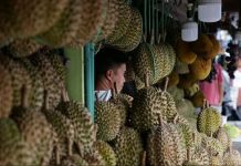 Durian and pomelo vendors man their stalls at a market in Davao City. GEORGE CALVELO/ABS-CBN NEWS PHOTO