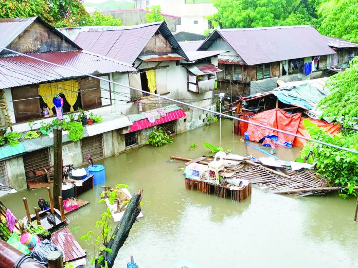flood_pic_1_resized Murky floodwaters engulf houses in Barangay Desamparados, Jaro, Iloilo City following heavy rains brought by the southwest monsoon or “habagat” on Thursday, June 1. AJ PALCULLO/PN