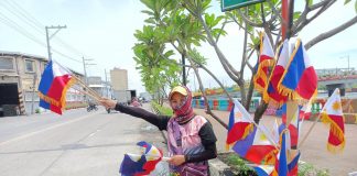 A woman sells miniature Philippine flags in Iloilo City. The Philippines celebrates National Flag Day from May 28 to June 12. On these dates, Filipinos are encouraged to display the Philippine flag in all offices, agencies and instruments of government, business establishments, schools, and private homes. AJ PALCULLO/PN