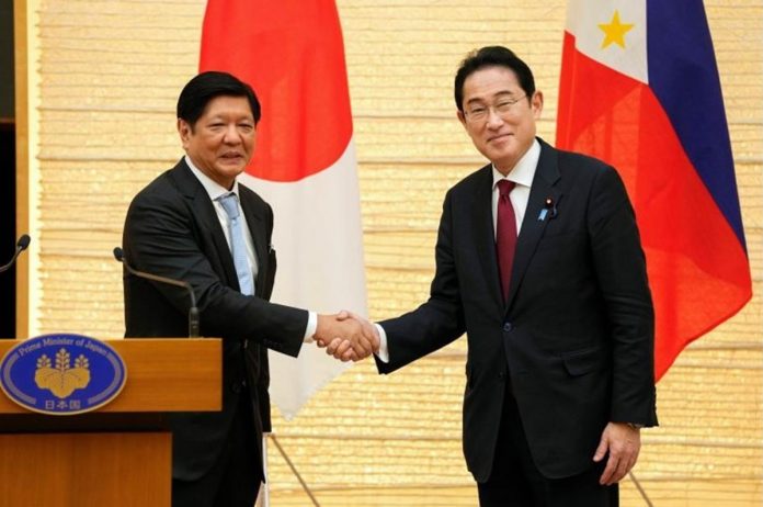 nation_japan_resized Japanese Prime Minister Fumio Kishida (right) shakes hands with Philippine President Ferdinand Marcos Jr. during a press conference in Tokyo on Feb. 9, 2023. KIMIMASA MAYAMA/POOL/AFP