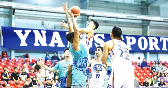 Ilonggo Clint Doliguez of the NLEX Road Warriors wards the defense of Antiqueño Tzaddy Rangel of Phoenix Super LPG Fuel Masters for a layup attempt. PBA PHOTO