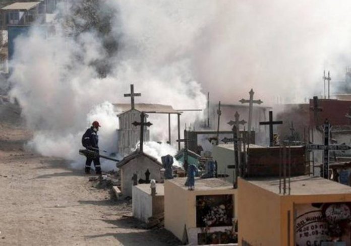 peru Huge vapour cloud as a worker sprays graves at a cemetery in Lima to protect against the spread of dengue fever. REUTERS