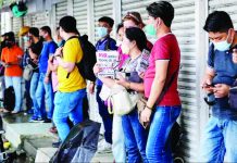 PH seafarers need upskilling – Marcos Job applicants take shelter from the rain as they line up outside the Luneta Seafarer’s Center in Manila. GEORGE CALVELO/ABS-CBN NEWS FILE PHOTO