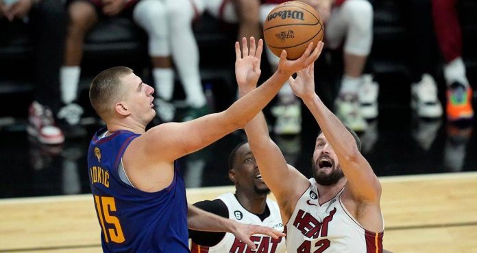 sports NBA Denver Nuggets’ Nikola Jokic (left) secures the ball from Miami Heat rivals. AP
