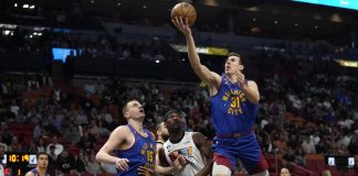 Denver Nuggets’ Vlatko Cancar (31) shoots over teammate Nikola Jokic (15) and Miami Heat’s Jimmy Butler (22) during their 2022-2023 NBA Regular Season game on Feb. 13, 2023. AP PHOTO/LYNNE SLADKY