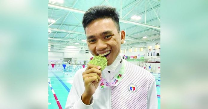 sports negrense_superimposed Medalist Ariel Joseph Alegarbes served as Team Philippines’ flag-bearer during the opening ceremony of the 12th ASEAN Para Games in Cambodia. PHOTO COURTESY OF PHILSPADA