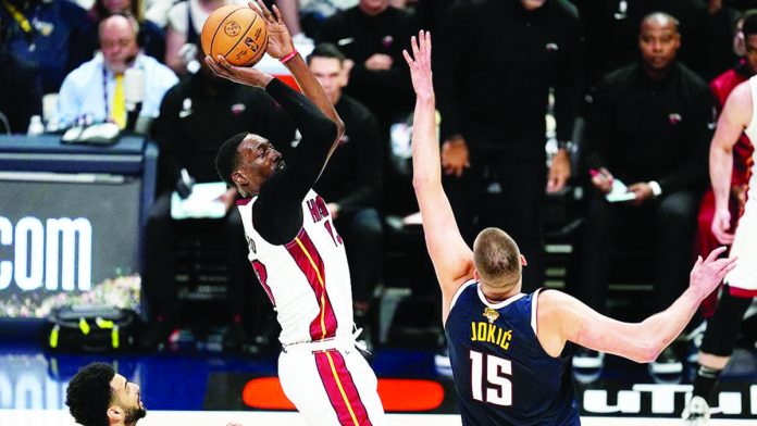sports_NBA_resized Miami Heat’s Bam Adebayo goes for a shot as Nikola Jokic of the Denver Nuggets tries to block him. AP