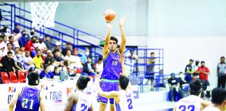 Converge FiberXers center Jeo Ambohot attempts a three-pointer while being defended by TNT Tropang Giga’s Carl Bryan Cruz. PBA PHOTO