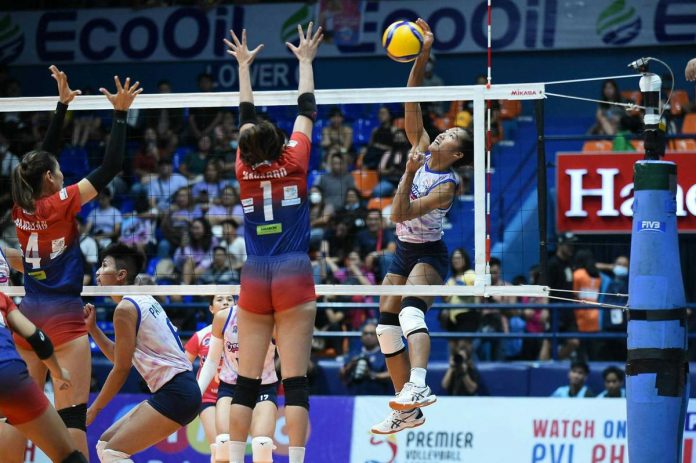 sports_creamline_resized Negrense Bernadeth Pons of Creamline Cool Smashers goes for an attack against the defense of Quezon City Gerflor Defenders’ Jannine Navarro. PVL PHOTO
