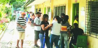 Member-consumer-owners of Central Negros electric Cooperative (Ceneco) queue to vote on the first day of plebiscite on Saturday, June 24, to ratify the joint venture agreement between Ceneco and Primelectric Holdings, Inc./Negros Electric Power Corporation