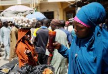 Nigeria gov’t declares state of emergency over foods scarcity Woman sells local food at a market in Kano, Nigeria. AP