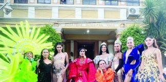 Dumangas cultural icon and historic first Grand Marshal Peter Solis Nery (seated) poses with colorful participants of the Dumangas Pride parade in front of the municipal hall.