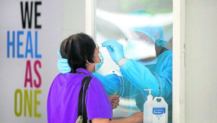 health_resized A woman undergoes swabbing procedures inside the UP-Philippine General Hospital. INQUIRER /LYN RILLON