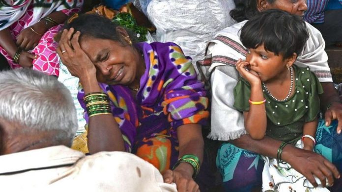 india_resized Relatives of people who lost their lives in a landslide weep in a house at Irshalwadi village in Raigad district of India's Maharashtra state. GETTY IMAGES