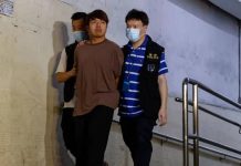 Hong Kong arrests activists Ivan Lam escorted by Hong Kong police. Photo courtesy of Reuters