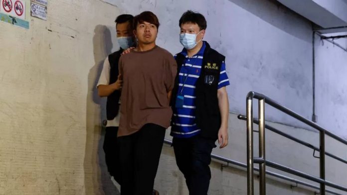 Ivan Lam escorted by Hong Kong police. Photo courtesy of Reuters