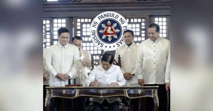 maharlika_superimposed President Ferdinand Marcos Jr. signs the Maharlika Investment Fund bill into law on Tuesday, July 18, 2023. PHOTO FROM RTV MALACAÑANG