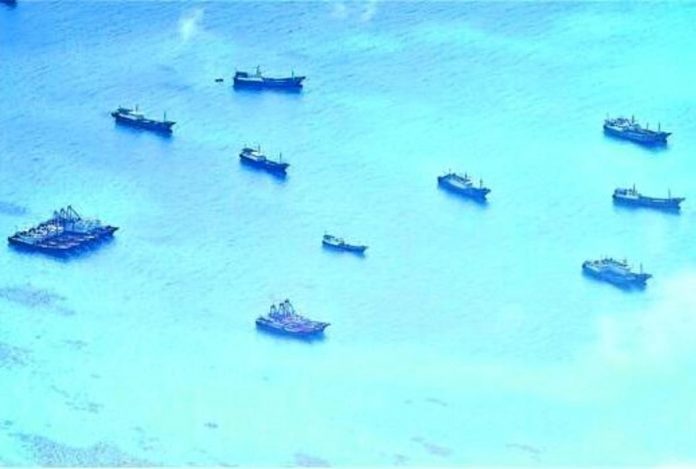 reef_resized WHERE’S THE FISH? A cluster of Chinese vessels is seen at Del Pilar (Iroquois) Reef on June 30. Pilots who took this photo noted that while they appeared to be fishing boats, they just lingered in the area and hardly engaged in any fishing activity. AFP WESCOMPHOTO