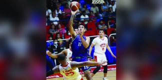 Converge FiberXers’ Justin Arana charges to the defense of Barangay Ginebra San Miguel Kings’ Raymond Aguilar for an inside shot. PBA PHOTO