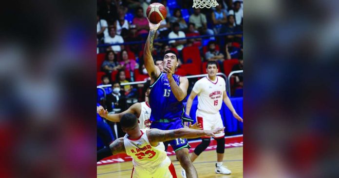 sports PBA_superimposed Converge FiberXers’ Justin Arana charges to the defense of Barangay Ginebra San Miguel Kings’ Raymond Aguilar for an inside shot. PBA PHOTO