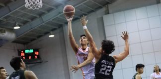 NorthPort Batang Pier’s Arvin Tolentino scores a floater against the defense of Terrafirma Dyip’s Javi Gomez de Liano. PBA PHOTO