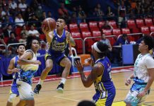 Magnolia Chicken Timplados Hotshots’ Jiovani Jalalon sits on the air as he goes for a layup.