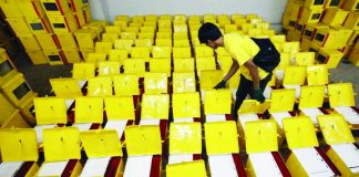 Commission on Elections (Comelec) Region 6 director Dennis Ausan (inset) says they are expecting this week the arrival of ballot boxes for the Barangay and Sangguniang Kabataan Elections. File photo shows a Comelec personnel inspecting ballot boxes in Metro Manila. ABS-CBN NEWS/FILE PHOTO