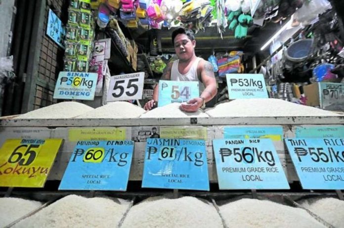 NFA_resized SIMULATED SHORTAGE? A rice vendor at Kamuning Public Market in Quezon City tends to his produce as the government readies rice imports. GRIG C. MONTEGRANDE, PHILIPPINE DAILY INQUIRER PHOTO