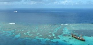 A China Coast Guard ship (upper left) is seen near the Philippine Navy’s BRP Sierra Madre as the Philippine Coast Guard conducts aerial surveillance at Sabina and Ayungin Shoals in the West Philippine Sea on February 21, 2023. INQUIRER/NIÑO JESUS ORBETA