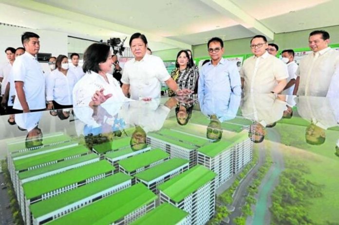 housing_resized SHELTER PROJECT. President Ferdinand Marcos Jr. and other government officials inspect a scale model for a government housing project in the City of San Fernando, Pampanga. PNA