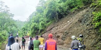 Residents and motorists climbed over piles of loose soil and rocks that temporarily closed the San Joaquin, Iloilo – Hamtic, Antique Road to all vehicle types on Sunday morning. SAN JOAQUIN DRRMC PHOTO