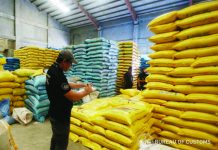 The Bureau of Customs leads the inspection of rice warehouses in Intercity Industrial Complex in San Juan, Balagtas, Bulacan on Aug. 24. They recovered about 202,000 sacks of imported rice grains from Vietnam, Cambodia and Thailand. BUREAU OF CUSTOMS PHOTO