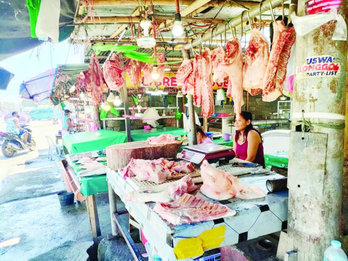 PH_meat_imports_resized A vendor tends to her stall selling meat products at a market in Barangay Tagbak, Jaro, Iloilo City. PN FILE PHOTO