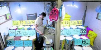 A vendor tends to his rice stall in Santa Ana, Manila, as a price ceiling for regular- and well-milled rice takes effect on Sept. 5, 2023. The government has promised to provide a subsidy for small rice retailers to partly cover their losses as they comply with the cap order. PHOTO BY MARIANNE BERMUDEZ / PHILIPPINE DAILY INQUIRER
