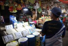 Personnel of the Municipal Agriculture Office and Business Permits and Licensing Office of Numancia, Aklan inspect rice prices at the Numancia Public Market on Sept. 6. NUMANCIA LGU PHOTO