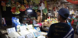Personnel of the Municipal Agriculture Office and Business Permits and Licensing Office of Numancia, Aklan inspect rice prices at the Numancia Public Market on Sept. 6. NUMANCIA LGU PHOTO
