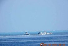 Chinese Coast Guard boats close to the floating barrier are pictured on Sept. 20, 2023, near the Scarborough Shoal in the South China Sea, in this handout image released by the Philippine Coast Guard on Sept. 24, 2023. PHILIPPINE COAST GUARD/HANDOUT VIA REUTERS
