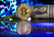 A bitcoin in front of a monitor shows a stock barometer in Duesseldorf, Germany. SASCHA STEINBACH, EPA-EFE/FILE PHOTO