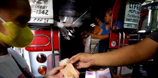 Commuters board a jeepney at the Tandang Sora terminal in Quezon City. The Land Transportation Franchising and Regulatory Board scheduled a hearing on Sept. 26 for transport groups' petition to add P5 to current P12 minimum fare due to the weekly oil price hikes. PNA